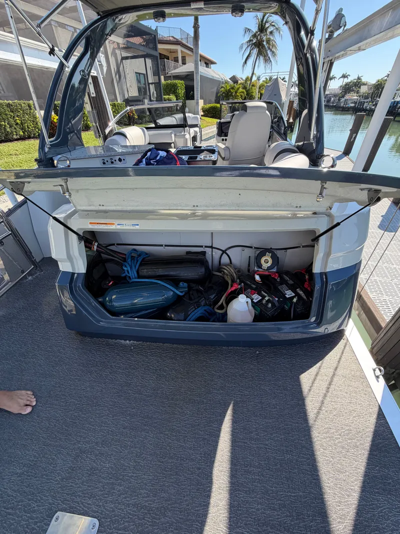 Slide: The Image of 2021 Avalon Excalibur Pontoon with open storage at the dock. - 9