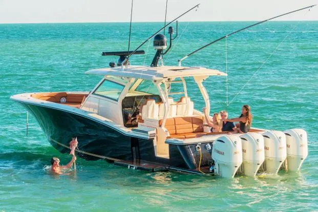 The Image of Manufacturer Provided Image: 2017 Scout 420 LXF boat with people relaxing and swimming in the ocean. - 0