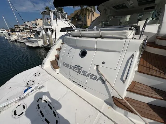 Slide: The Image of 2008 Sea Ray 55 Sundancer yacht docked, featuring "Obsession" name on the stern. - 22