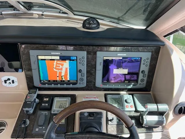 Slide: The Image of Control panel of a 2008 Sea Ray 55 Sundancer yacht with navigation screens and instruments. - 4