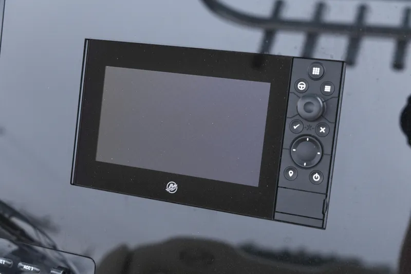 Slide: The Image of 2020 Key West 239 FS boat dashboard with control panel and display screen. - 16