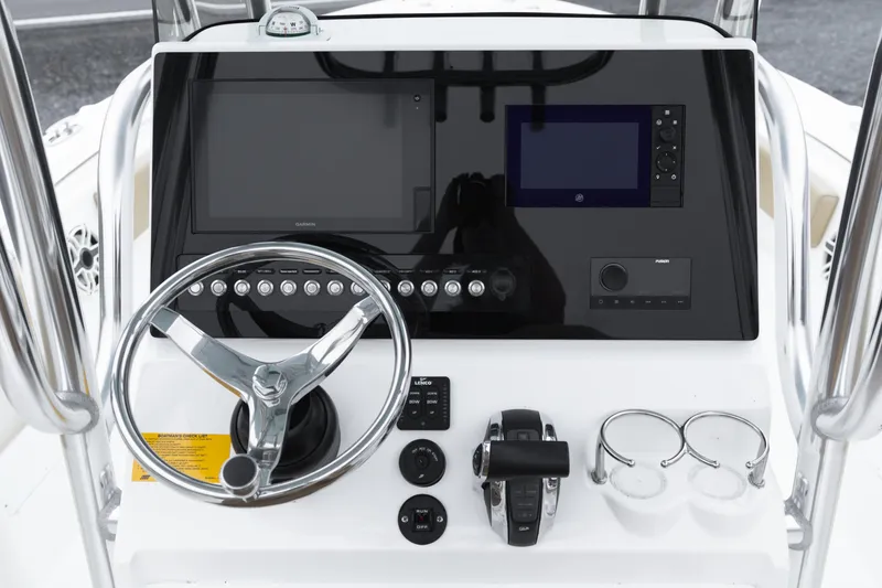 Slide: The Image of 2020 Key West 239 FS boat dashboard with steering wheel and navigation controls. - 18