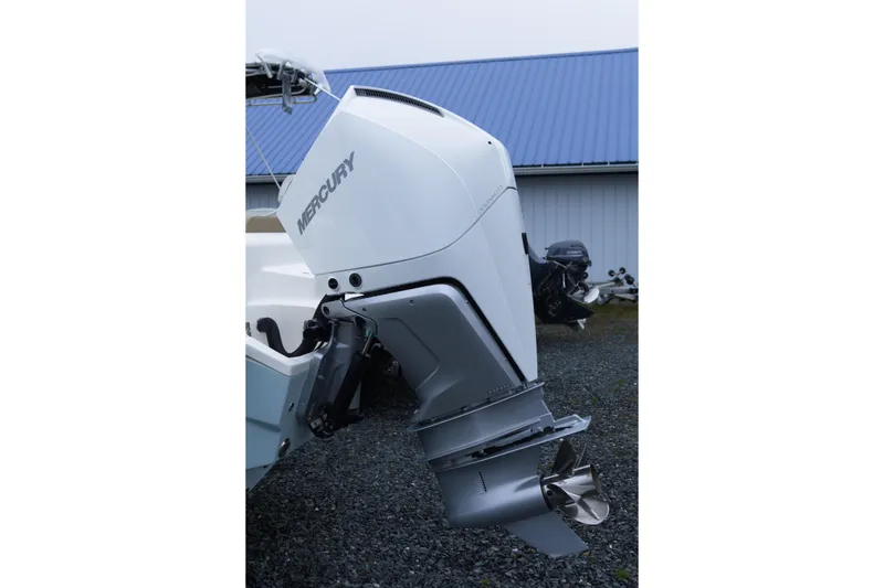 Slide: The Image of 2020 Key West 239 FS boat with Mercury outboard motor, parked on gravel. - 3