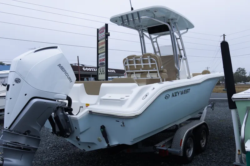 Slide: The Image of 2020 Key West 239 FS boat with Mercury engine on trailer, displayed outdoors. - 6