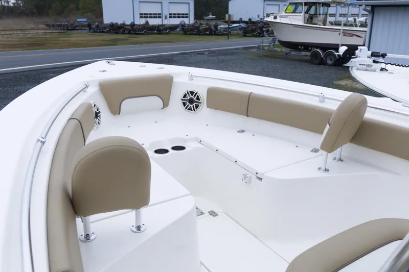 Slide: The Image of 2020 Key West 239 FS boat interior with beige seating and cup holders. - 8