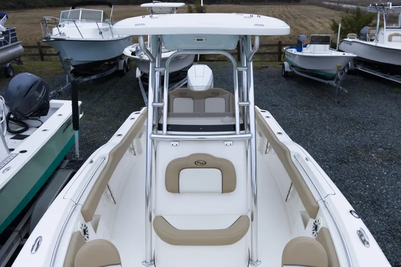 Slide: The Image of 2020 Key West 239 FS boat with beige seating, parked among other boats. - 9