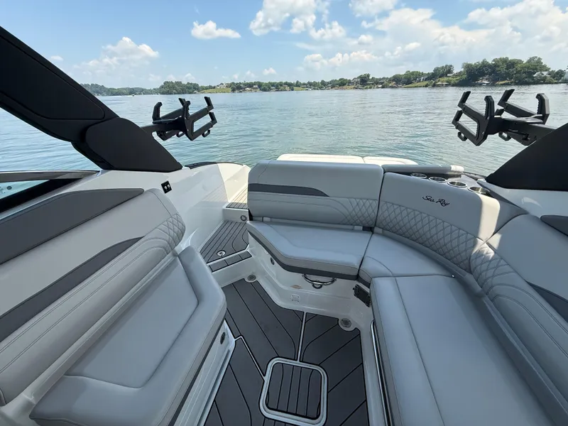 Slide: The Image of 2023 Sea Ray SLX 260 Surf boat interior with luxurious seating and scenic water view. - 27