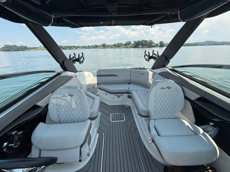 Slide: The Image of 2023 Sea Ray SLX 260 Surf boat interior with luxurious seating and lake view. - 28