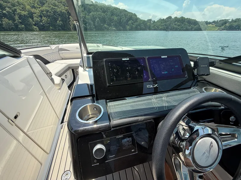 Slide: The Image of 2023 Sea Ray SLX 260 Surf boat interior with modern dashboard and steering wheel. - 29