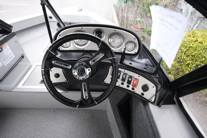 Slide: The Image of 2023 SMOKERCRAFT 172 Osprey boat dashboard with steering wheel and control panel. - 10
