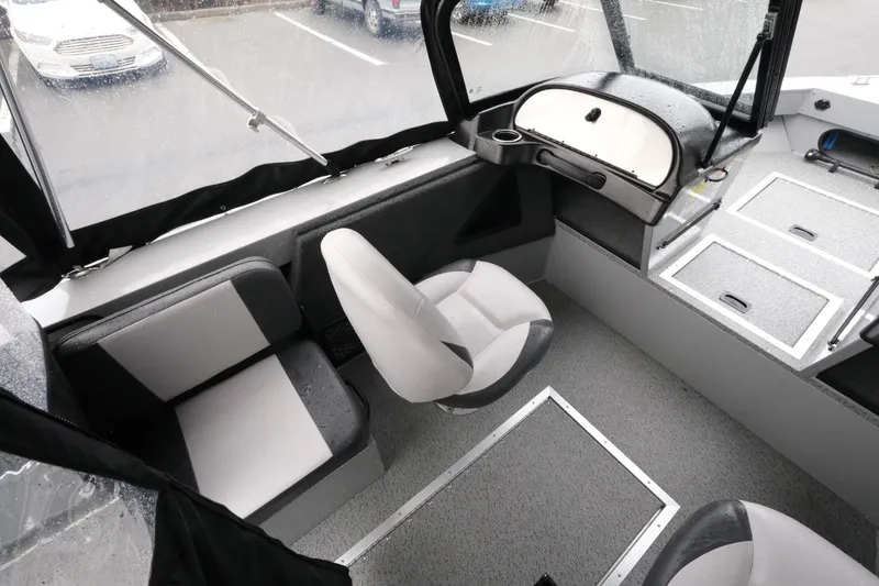 Slide: The Image of 2023 SMOKERCRAFT 172 Osprey boat interior with seating and dashboard, showcasing modern design. - 11