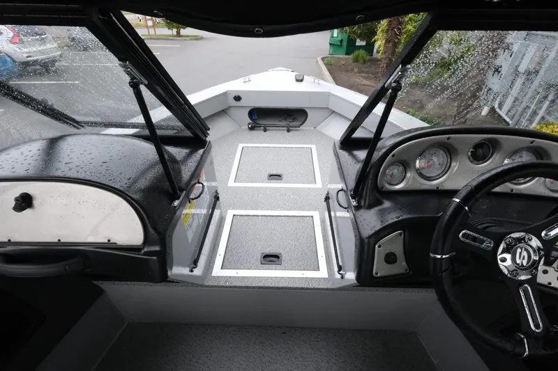 Slide: The Image of 2023 SMOKERCRAFT 172 Osprey boat interior with dashboard and storage compartments. - 13