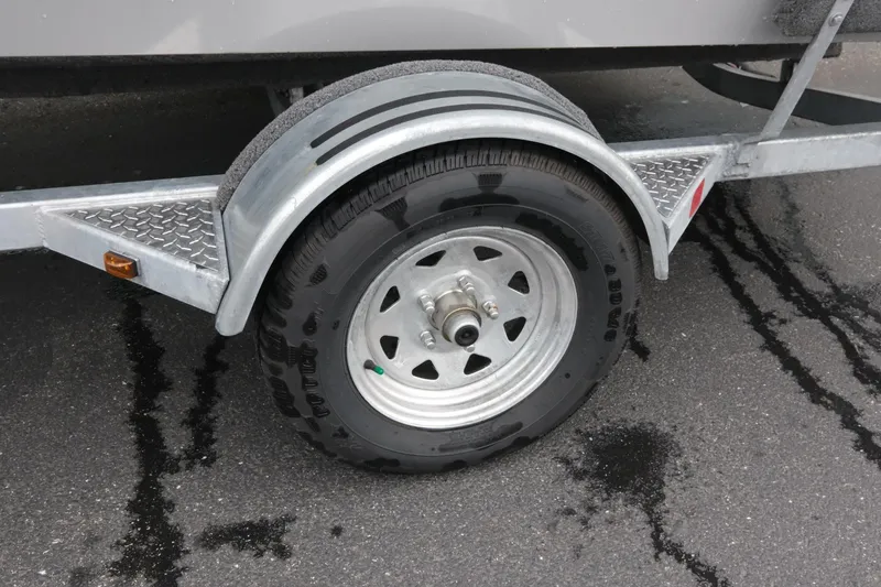 Slide: The Image of Trailer wheel of 2023 SMOKERCRAFT 172 Osprey on wet pavement. - 15