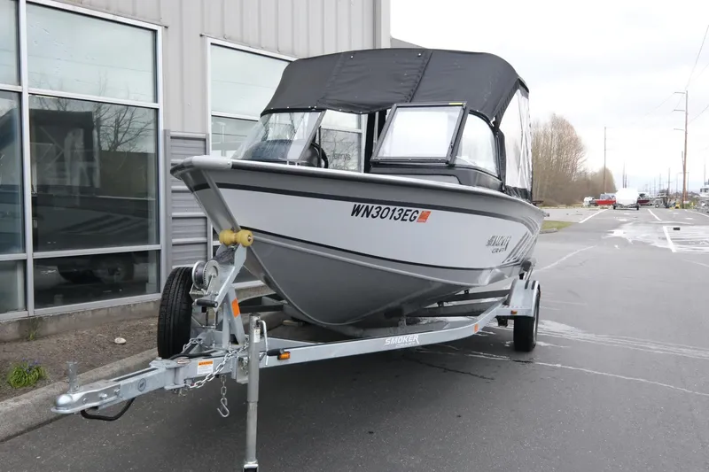 Slide: The Image of 2023 SMOKERCRAFT 172 Osprey boat on trailer, parked outside a building. - 3