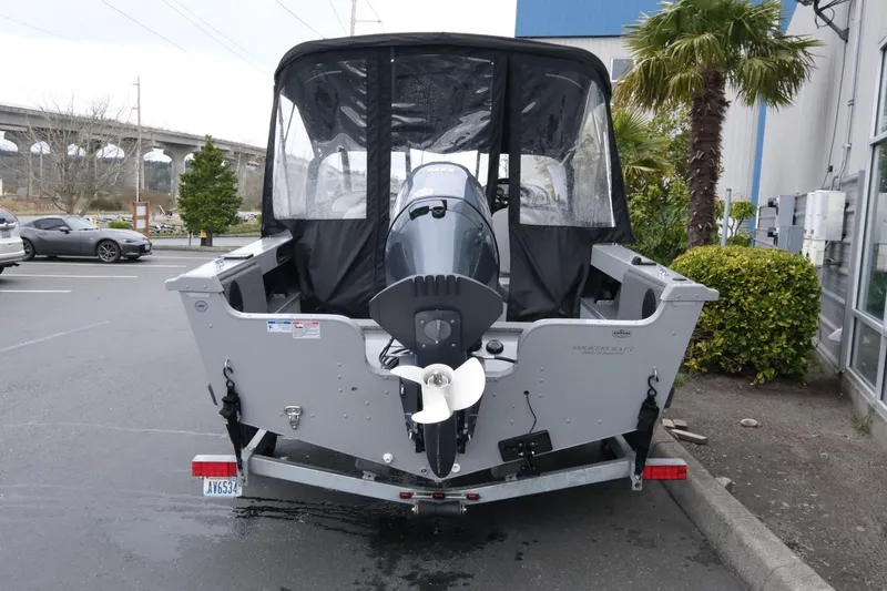Slide: The Image of 2023 SMOKERCRAFT 172 Osprey boat with outboard motor, parked outdoors. - 6