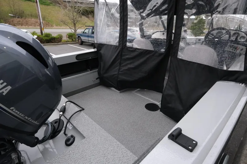 Slide: The Image of 2023 SMOKERCRAFT 172 Osprey boat interior with Yamaha engine and protective canopy. - 7
