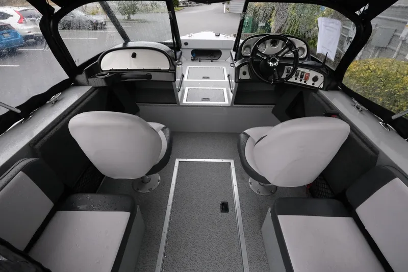 Slide: The Image of Interior of 2023 SMOKERCRAFT 172 Osprey boat with seating and steering console. - 8