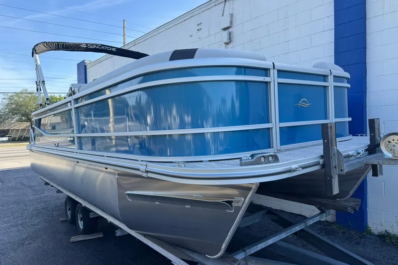 Slide: The Image of 2026 SunCatcher Select 22RF pontoon boat on trailer, blue and silver design. - 11