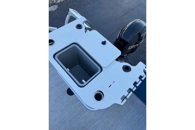 Slide: The Image of SunCatcher Select 22RF 2026 boat with open storage compartment and motor. - 15