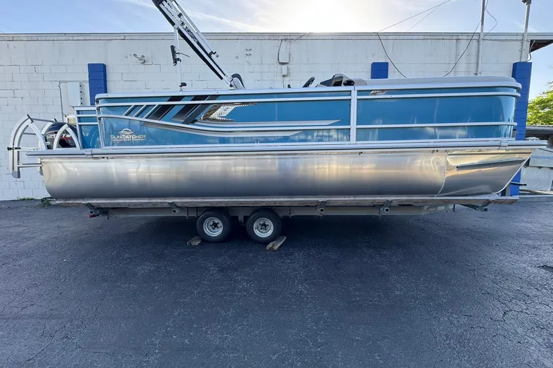 The Image of 2026 SunCatcher Select 22RF pontoon boat on trailer, blue and silver design. - 6