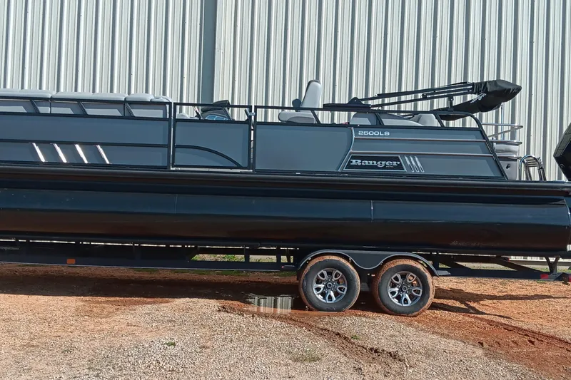 The Image of 2023 Ranger 2500LS pontoon boat on trailer, parked outdoors. - 0