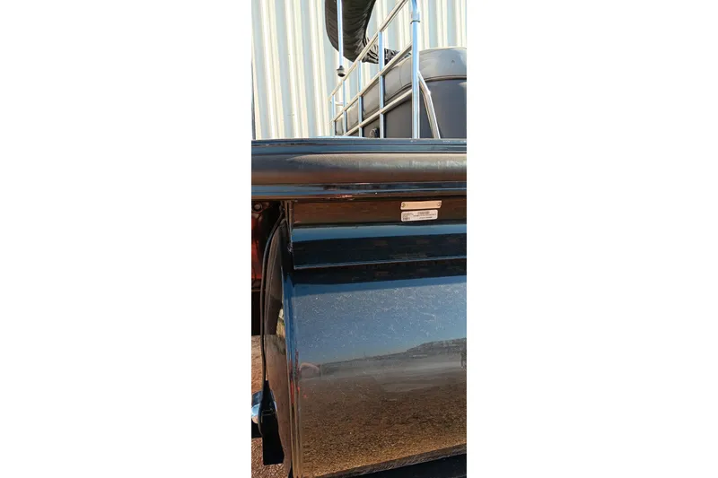 Slide: The Image of 2023 Ranger 2500LS boat detail with metal railing and reflective surface. - 10