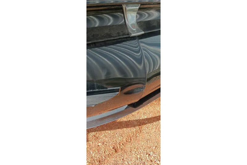 Slide: The Image of Close-up of a 2023 Ranger 2500LS boat hull on a sandy surface. - 15
