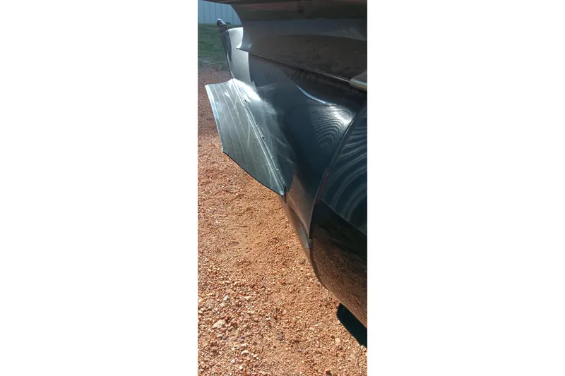 Slide: The Image of Close-up of a 2023 Ranger 2500LS boat hull on gravel surface. - 16