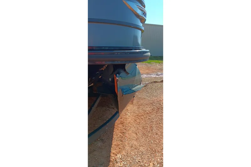 Slide: The Image of 2023 Ranger 2500LS boat hull detail on gravel surface. - 21