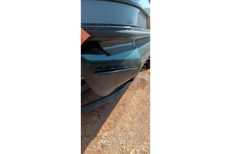 Slide: The Image of Close-up of a 2023 Ranger 2500LS boat hull on a gravel surface. - 22