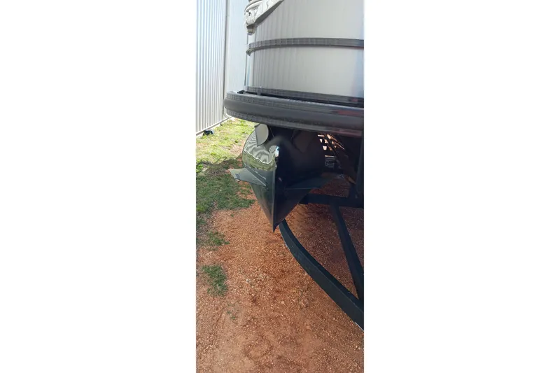 Slide: The Image of 2023 Ranger 2500LS boat trailer hitch on gravel near metal building. - 23