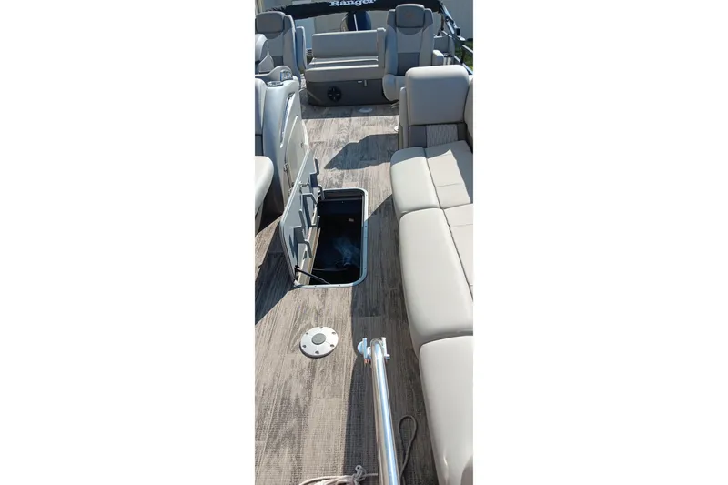 Slide: The Image of 2023 Ranger 2500LS boat interior with open storage compartment and beige seating. - 26