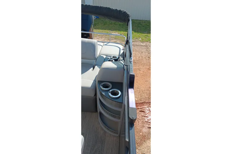 Slide: The Image of 2023 Ranger 2500LS boat interior with cup holders and seating area. - 30