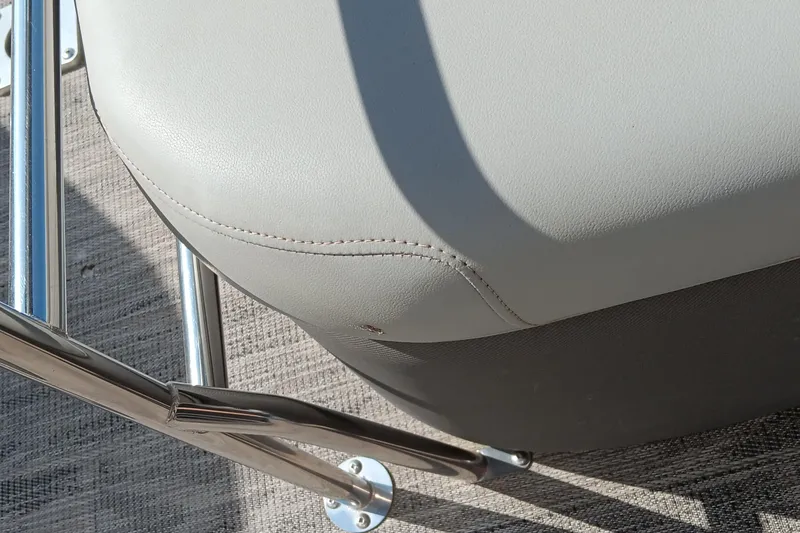Slide: The Image of Close-up of a 2023 Ranger 2500LS boat seat with metal railing. - 34