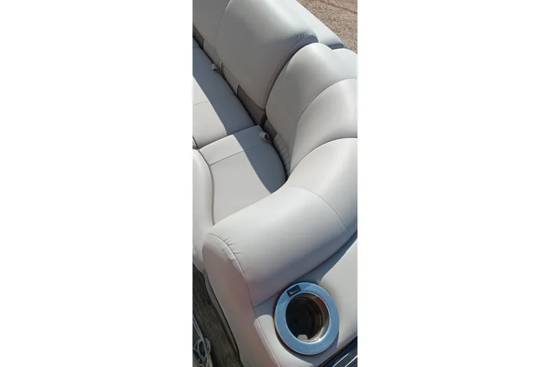 Slide: The Image of 2023 Ranger 2500LS boat seat with cup holder, featuring light gray upholstery. - 35
