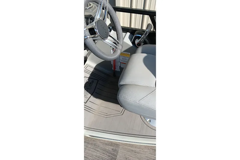 Slide: The Image of 2023 Ranger 2500LS boat interior with steering wheel and seat detail. - 41