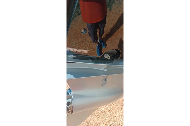 Slide: The Image of Reflection on Ranger 2500LS boat surface, showing person and surroundings, 2023 model. - 42