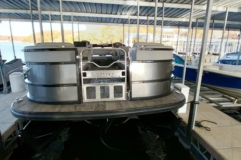 Slide: The Image of 2023 Ranger 2500LS pontoon boat docked in a covered marina. - 47