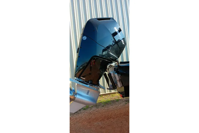 Slide: The Image of 2023 Ranger 2500LS boat motor, Mercury engine, outdoors near corrugated metal wall. - 5