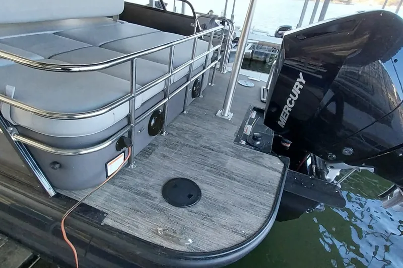Slide: The Image of 2023 Ranger 2500LS boat with Mercury engine, docked on water. - 54