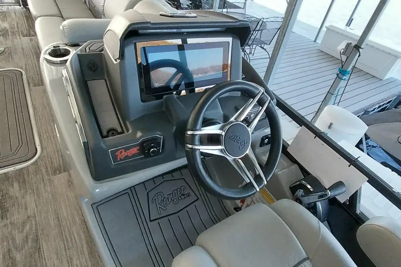 Slide: The Image of 2023 Ranger 2500LS boat dashboard with steering wheel and touchscreen display. - 56