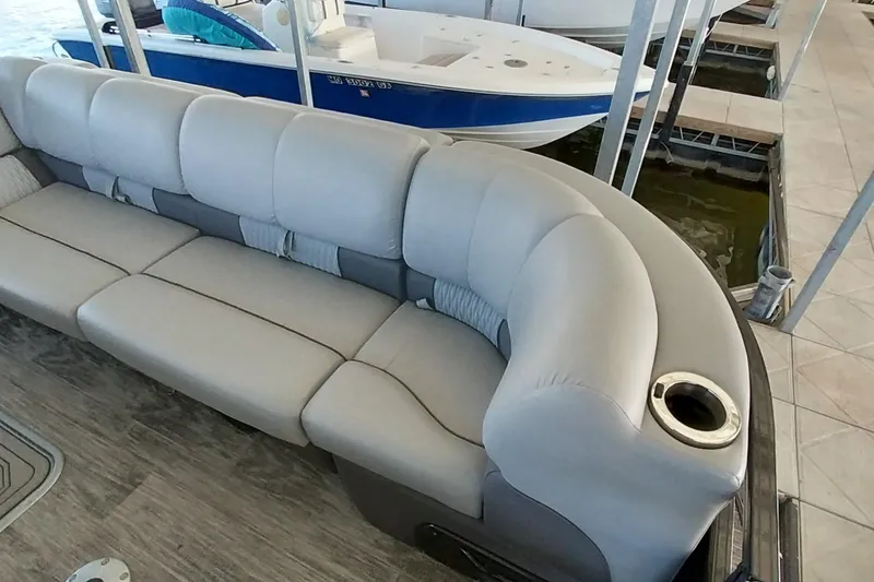 Slide: The Image of Luxurious seating on 2023 Ranger 2500LS boat, featuring plush upholstery and cup holder. - 59