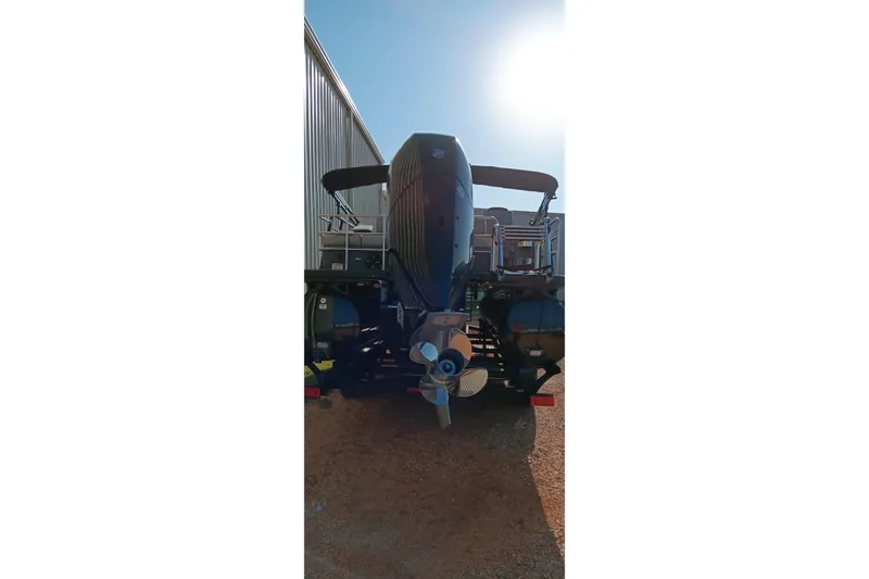 Slide: The Image of Rear view of 2023 Ranger 2500LS boat with outboard motor in sunlight. - 6