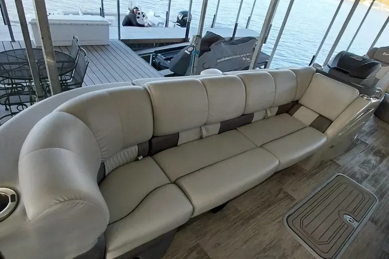 Slide: The Image of Luxurious seating on 2023 Ranger 2500LS pontoon boat, docked by the water. - 60