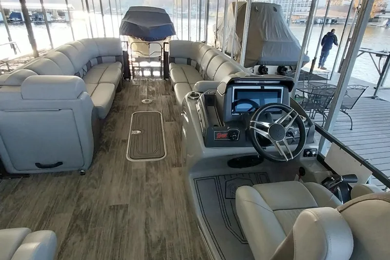 Slide: The Image of Luxurious 2023 Ranger 2500LS pontoon boat interior with plush seating and modern helm. - 61