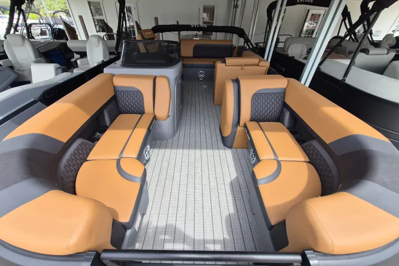 Slide: The Image of 2026 Sylvan L3 DLZ Bar pontoon boat interior with tan and gray seating. - 2