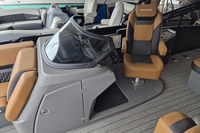 Slide: The Image of 2026 Sylvan L3 DLZ Bar boat interior with tan and black seating, sleek helm design. - 4