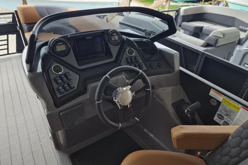 Slide: The Image of 2026 Sylvan L3 DLZ Bar boat dashboard with steering wheel and control panel. - 5