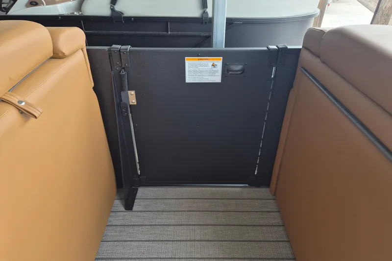 Slide: The Image of Interior view of 2026 Sylvan L3 DLZ Bar boat with tan seating and safety gate. - 6