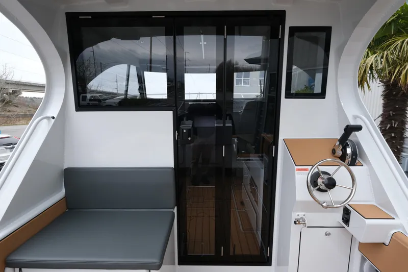 Slide: The Image of Interior view of 2026 Makaira 28 boat with seating and steering wheel. - 10